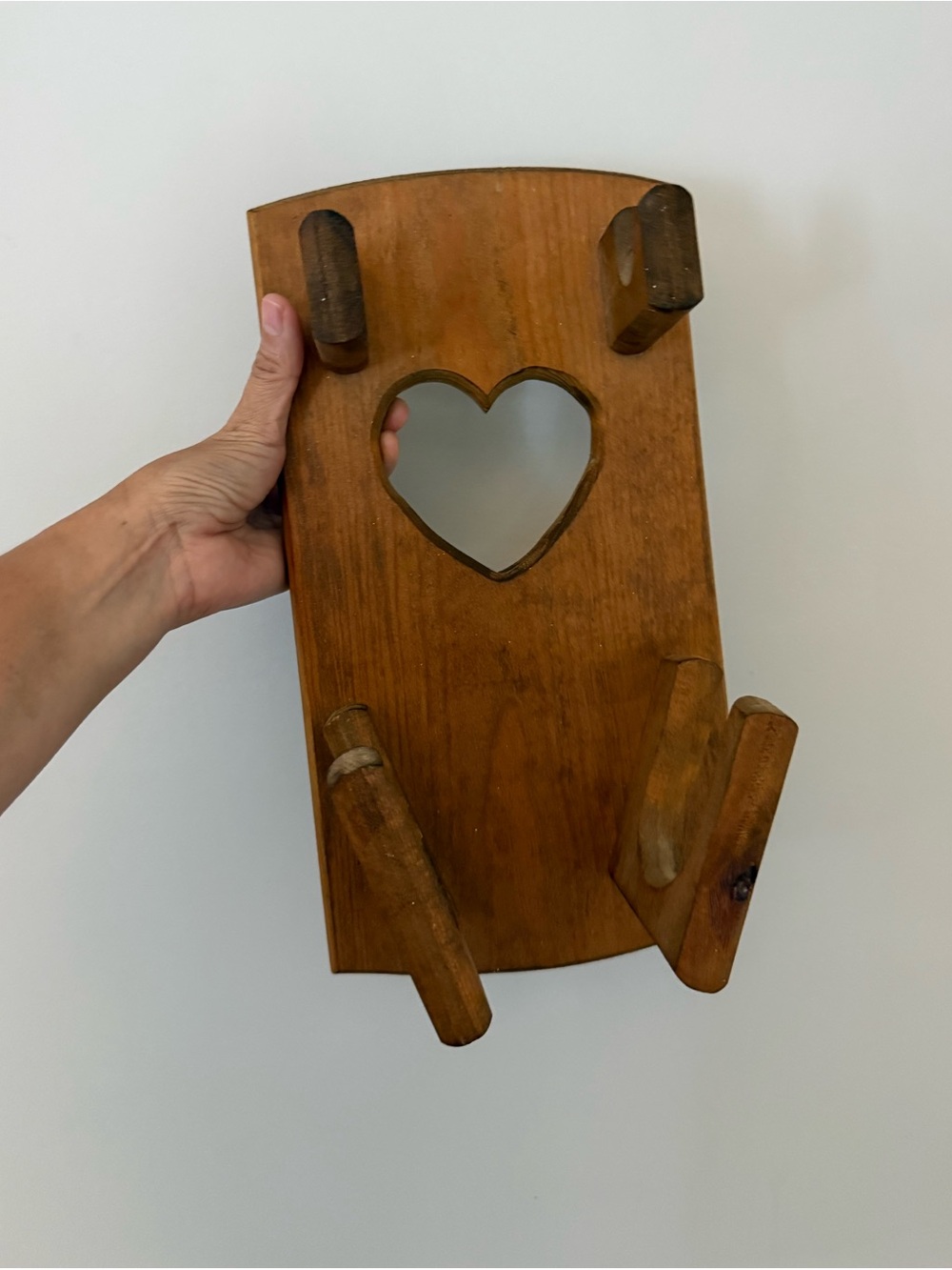 Vintage wall-mounted wooden hair dryer and styling tool organizer. Heart design